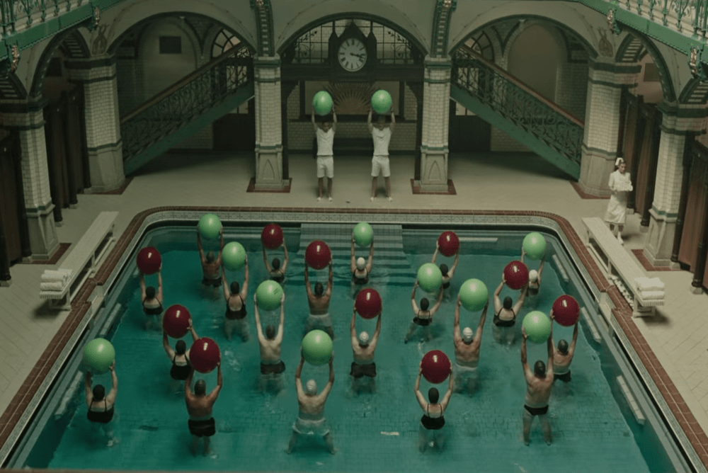 group in a pool holding spheres