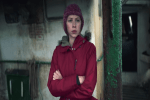 woman in red jacket with arms crossed