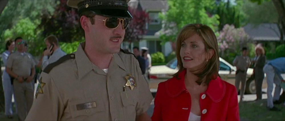 police officer and a woman have a conversation outside