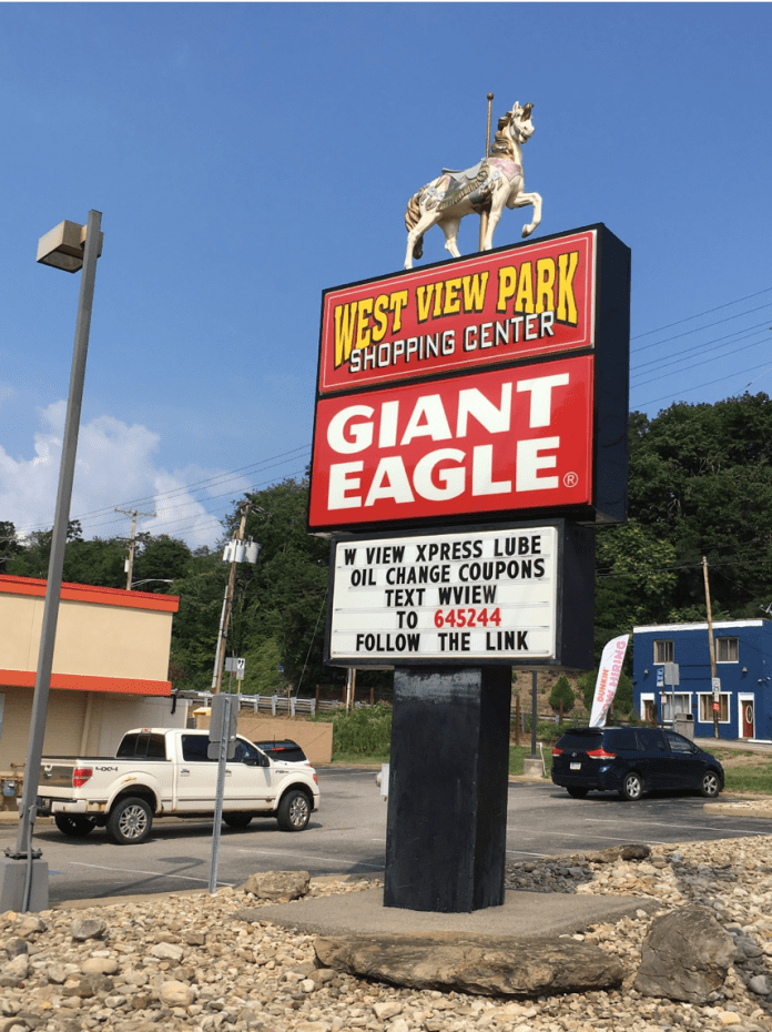 sign that says Giant Eagle with a horse on its top