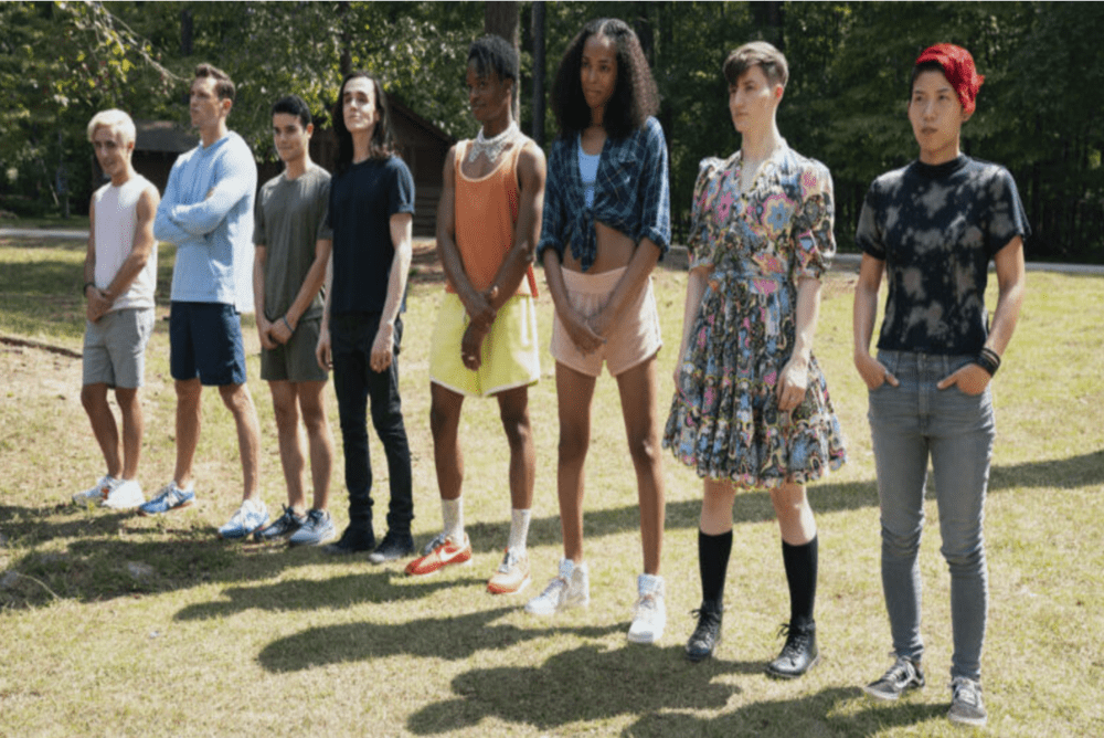 a group of young people stand in defiance of people trying to oppress them