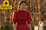 A young woman wearing a red dress stares forlornly while standing in a cornfield. Her makeup is smeared.